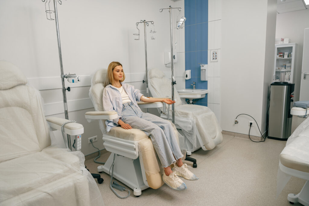 A woman sitting in an operating room chair.